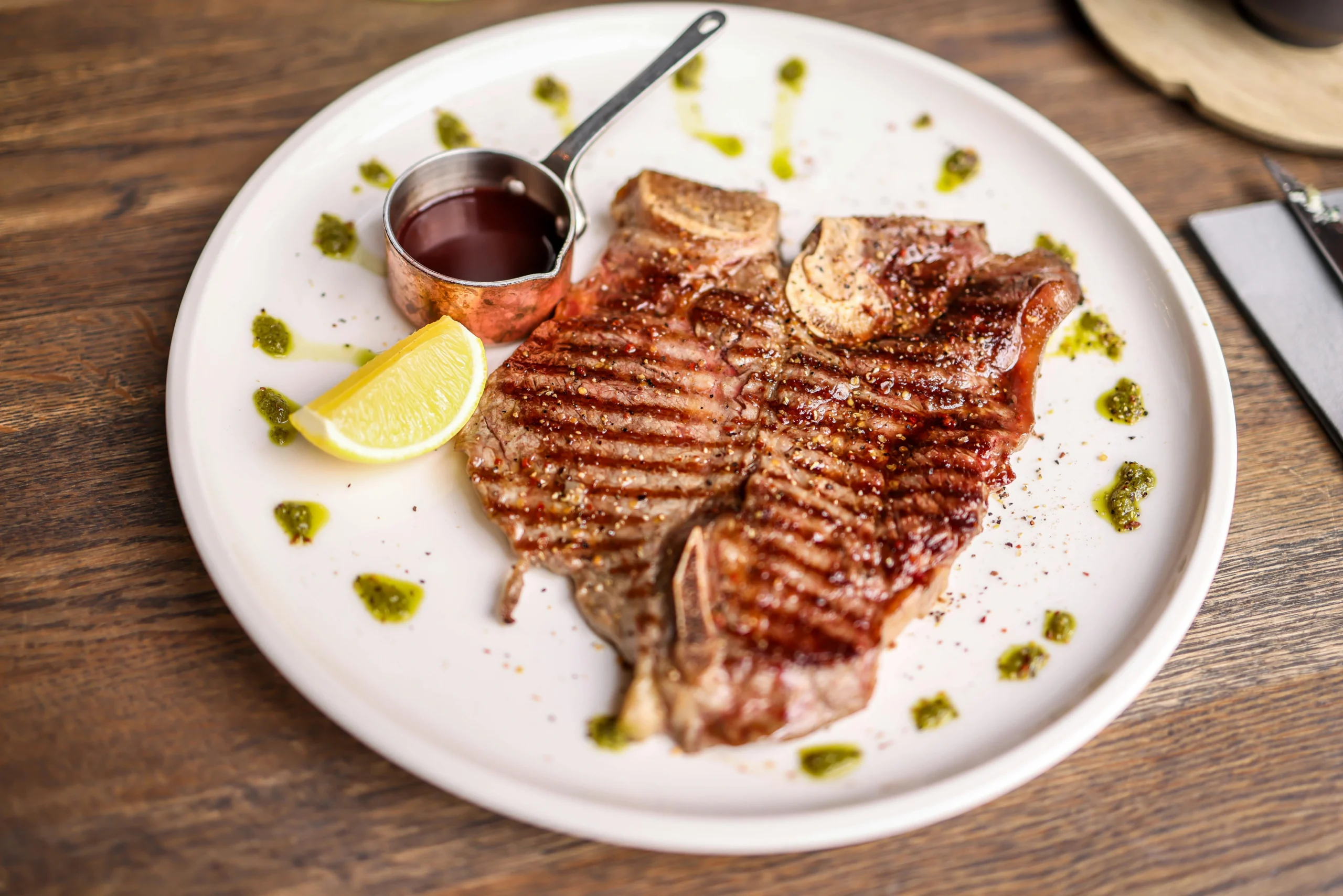 Texas Roadhouse Porterhouse T-Bone 23oz — massive hand-cut steak combining strip and filet on the bone